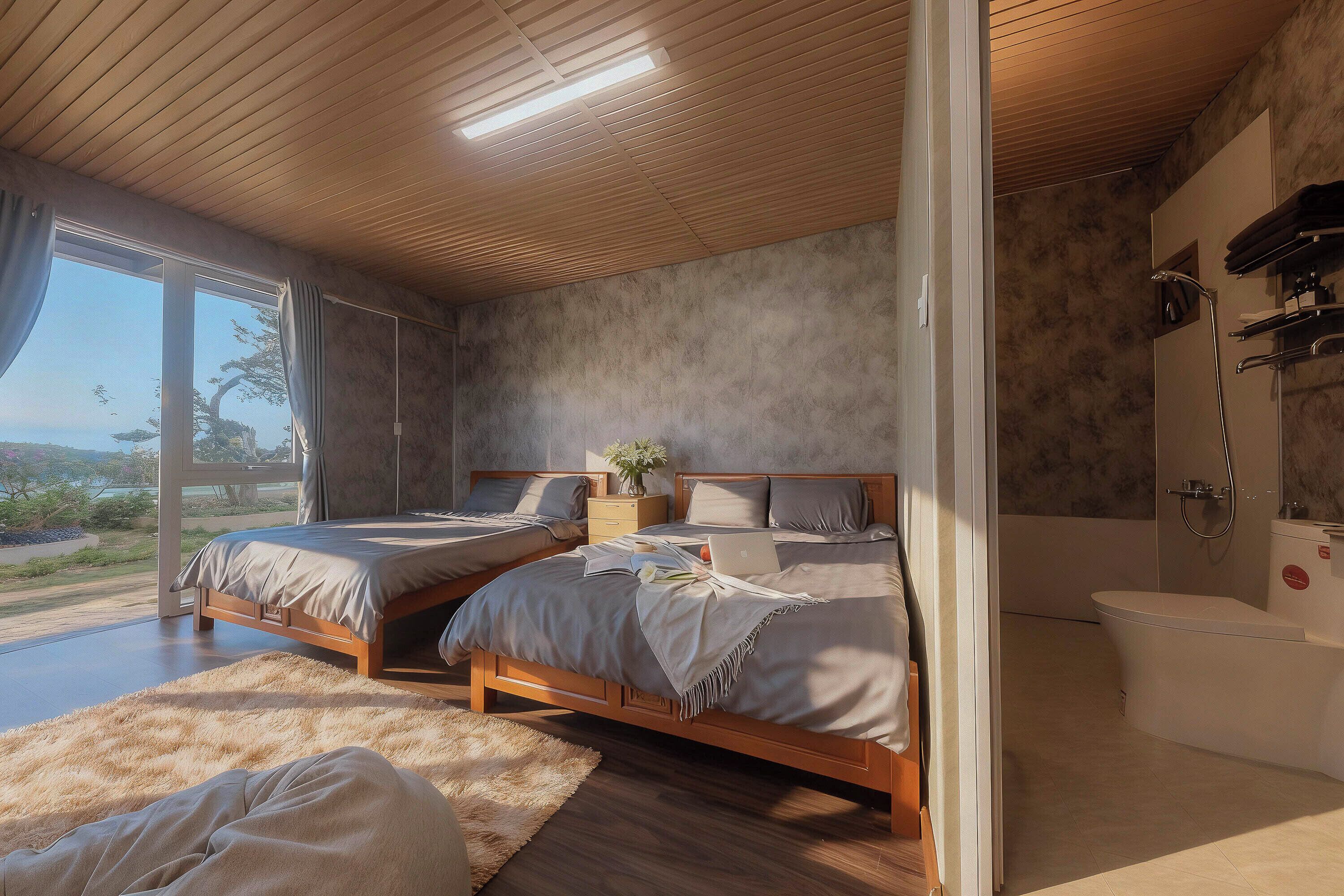 A bedroom with two beds, a large window, a shower, and a view of the outdoors.