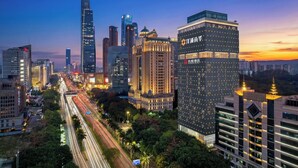 A cityscape with modern high-rise buildings, a prominent skyscraper, and a busy street with light trails. - ECHENG Hotel (Nanning Mixc City Exhibition Branch) (Nanning)