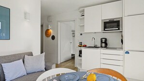 A modern kitchen with white cabinets, a built-in oven, and a coffee maker. - Seemomente 615 (Seenähe) by Interhome (Lembruch)