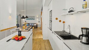 A modern kitchen with a central island, a built-in oven, and a coffee maker. - Seelykke 304 by Interhome (Lembruch)