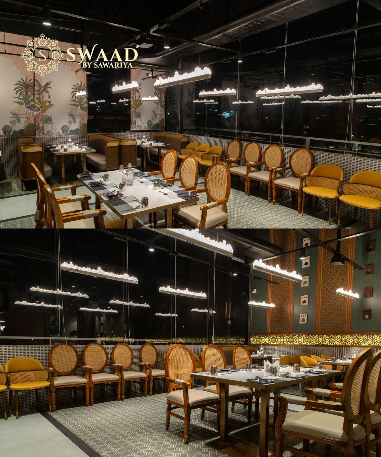 A restaurant interior with tiered seating, hanging pendant lights, and a decorative wall mural.