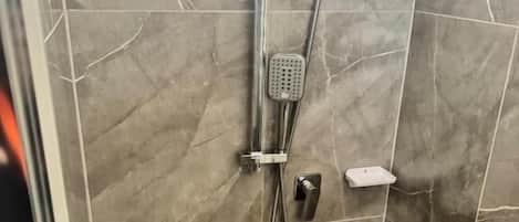 Shower, towels, soap, toilet paper