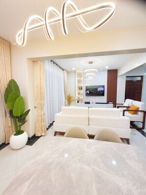 Family Apartment, Balcony, City View | Living area | Flat-screen TV - Charm Luxe Homes (Kampala)
