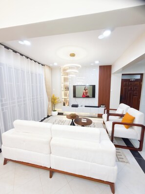 Family Apartment, Balcony, City View | Living area | Flat-screen TV - Charm Luxe Homes (Kampala)