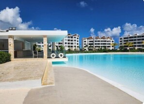 Outdoor pool - Relax by the 30,000 m² Crystal Lagoon – Stylish 2BR Apt. 5 min drive Downtown PC (punta cana)
