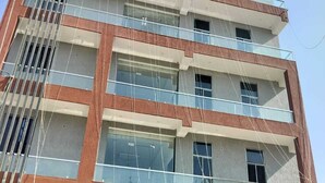 A multi-story hotel named "HOTEL PARADISE" with a modern facade, large windows, and a visible balcony on the upper floors. - Hotel Paradise (Danta Ramgarh)