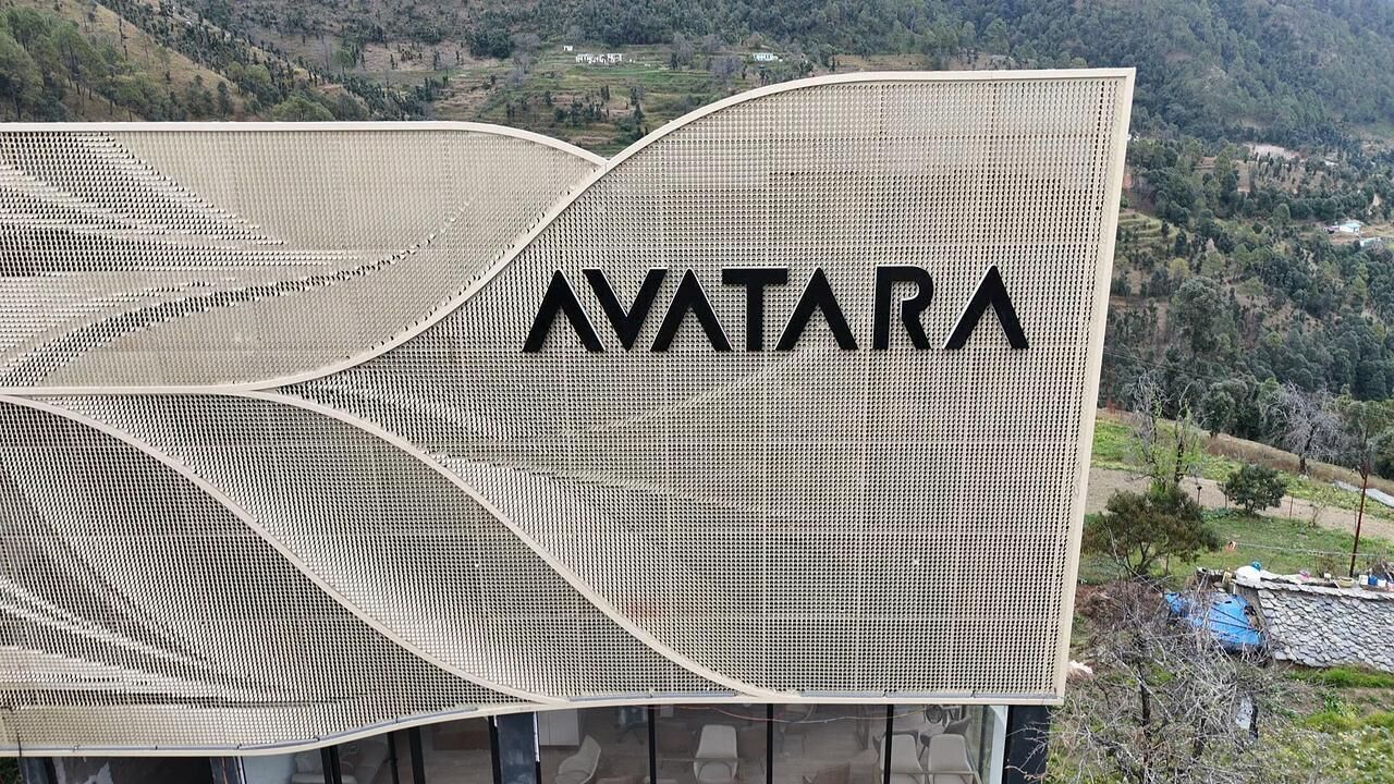 A building with a unique wave-like architectural design and the word "AVATAR" prominently displayed on its facade.