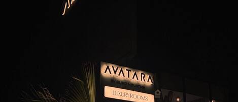 A signboard for 'AVATAR' with options for 'LUXURY ROOMS,' 'RESTAURANT,' 'ROOFTOP CAFE,' and 'DORMITORY.'