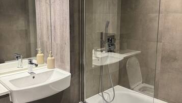 Shower, hair dryer, towels, soap