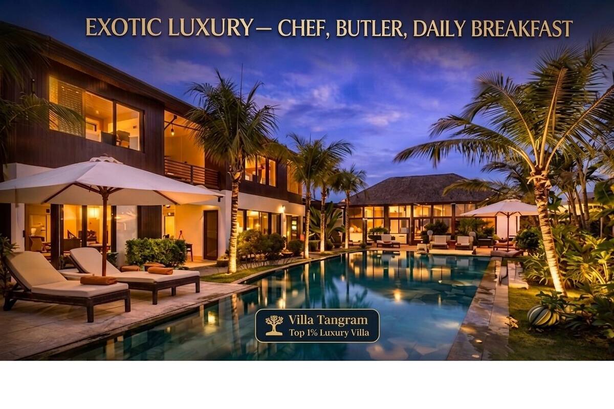 A luxury villa with a swimming pool, lounge chairs, and a well-lit outdoor area.