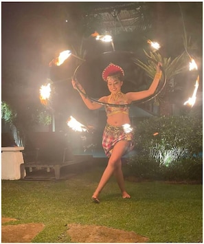 A person performing an act with fire props in an outdoor setting. - Villa Abagram Seminyak (Seminyak)