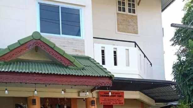 A building with a green roof and a signboard. - Manee Guest House (Chiang Mai)