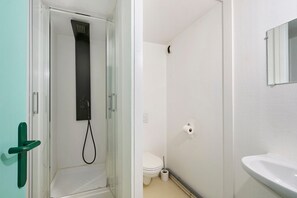 Ein Badezimmer mit Dusche, Toilette und Waschbecken.