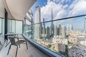 Outdoor dining - High-Floor Balcony with Burj Khalifa View & Asst Room, Minutes from Burj Plaza (Dubai)