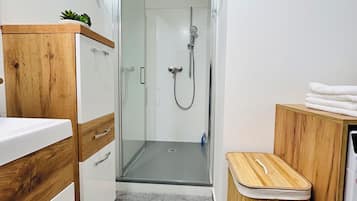 Shower, hair dryer, towels, toilet paper