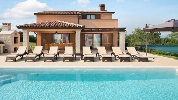 A poolside area with lounge chairs and a covered seating area. - Villa San Martino With Heated Pool , Outside Jacuzzi & Hydromassage Bathub (Sveta Nedelja)