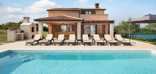 A poolside area with lounge chairs and a covered seating area. - Villa San Martino With Heated Pool , Outside Jacuzzi & Hydromassage Bathub (Sveta Nedelja)
