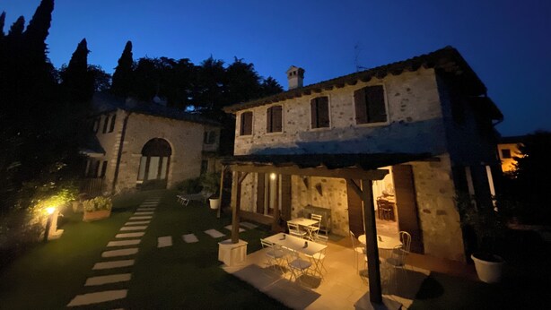 A stone building with a covered patio and outdoor seating area. - Ca' Malfer B&B (Marciaga)
