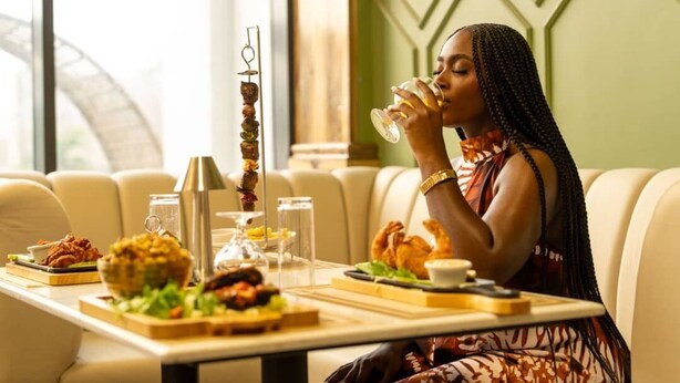 A dining area with a table set for a meal, including a variety of dishes and drinks. - Julirose Hotel and Suites (Port Harcourt)