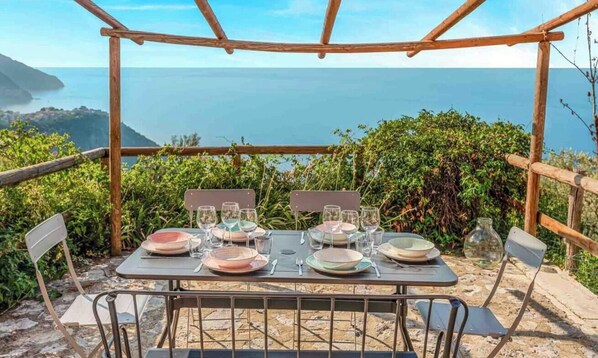Outdoor dining - Blu Isola, located in Prevo, a few minutes drive from Corniglia, is the perfect choice for a family or group of friends.The outdoor terrace, with barbecue available, is the perfect place to relax and admire the breathtaking sunsets over the Cinque Terre  (Vernazza)