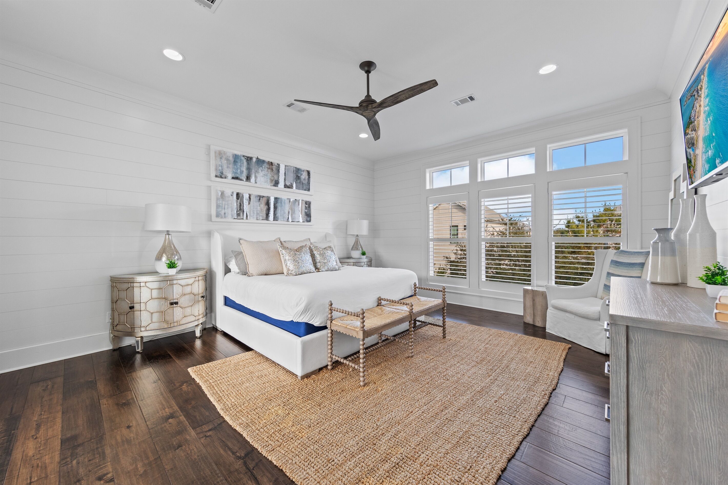 The primary king bedroom offers a spacious, light-filled retreat with an open layout, private outdoor deck, and a peaceful coastal feel. Thoughtfully designed for rest and relaxation, with a private ensuite that completes this elevated third-floor escape.