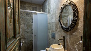A bathroom with a shower, toilet, sink, and ornate mirror. - cappadocia keyfiala hotel (Urgup)