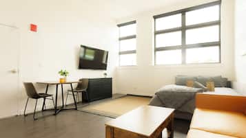 Departamento, 1 cama Queen size, vista a la ciudad | Área de sala de estar | Televisión de pantalla plana de 42 pulgadas con canales por cable