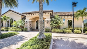 A building with a stone facade, arched windows, and a tiled roof. - Charming 3-bedroom pool house in Sarasota, 5-minutes from Siesta Key beach (Sarasota)