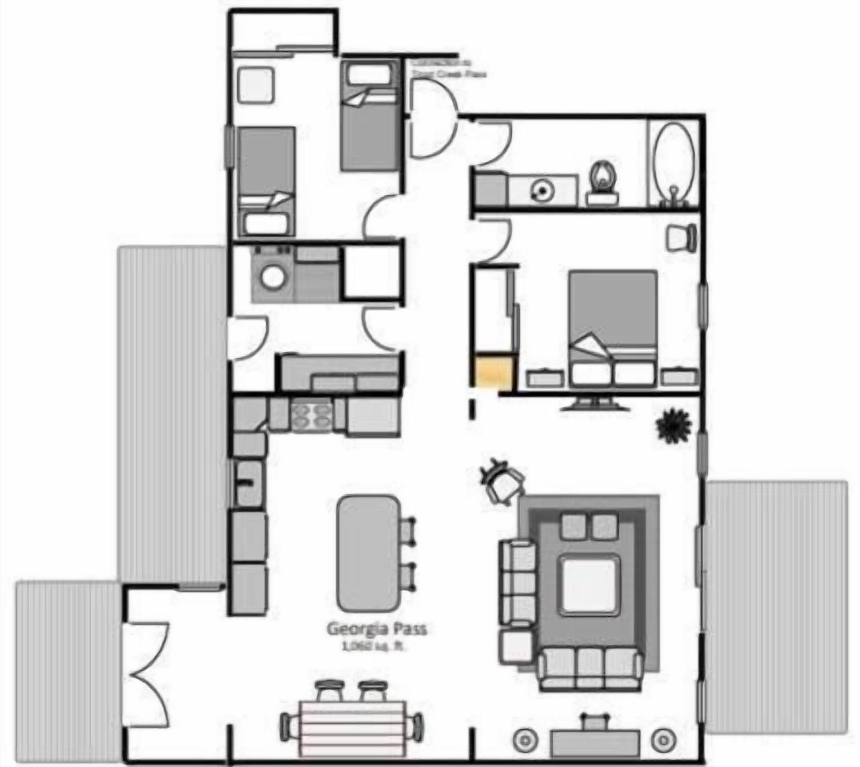 A floor plan of a hotel room with a kitchenette, a living area with a sofa and TV, a bathroom, and a small balcony.