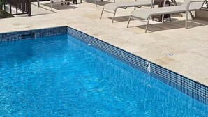 A pool area with lounge chairs and a view of the ocean. - Piscina Vista Guest House w/ Solar & Pool (Ceiba)