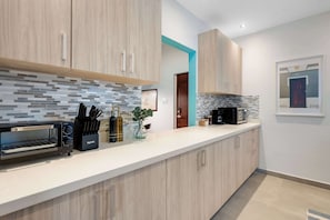Full kitchen with long counter and coffee station - Condado 3BR w/ Balcony | Pool | Walk to Beach (San Juan)