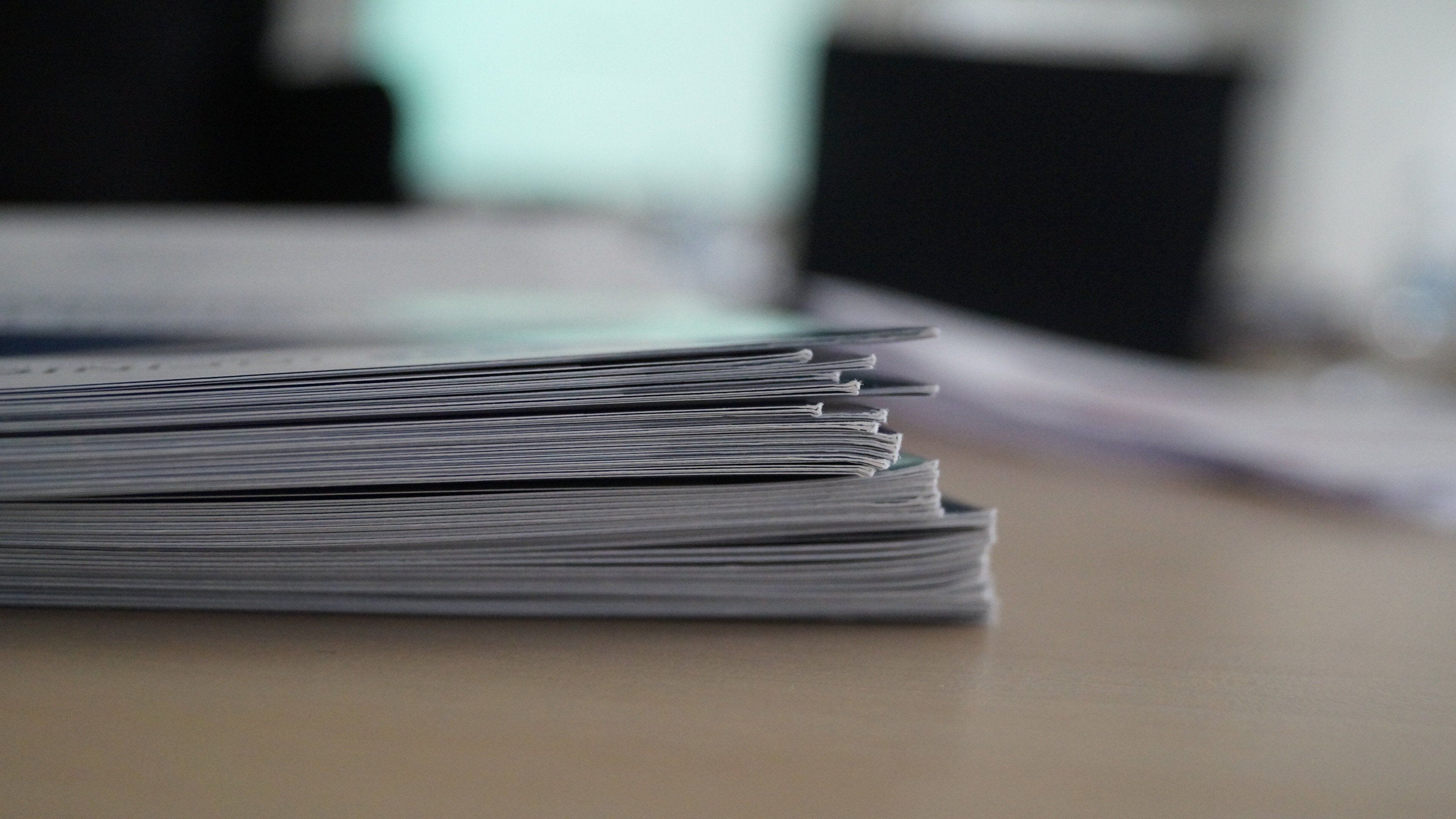A stack of papers on a flat surface.