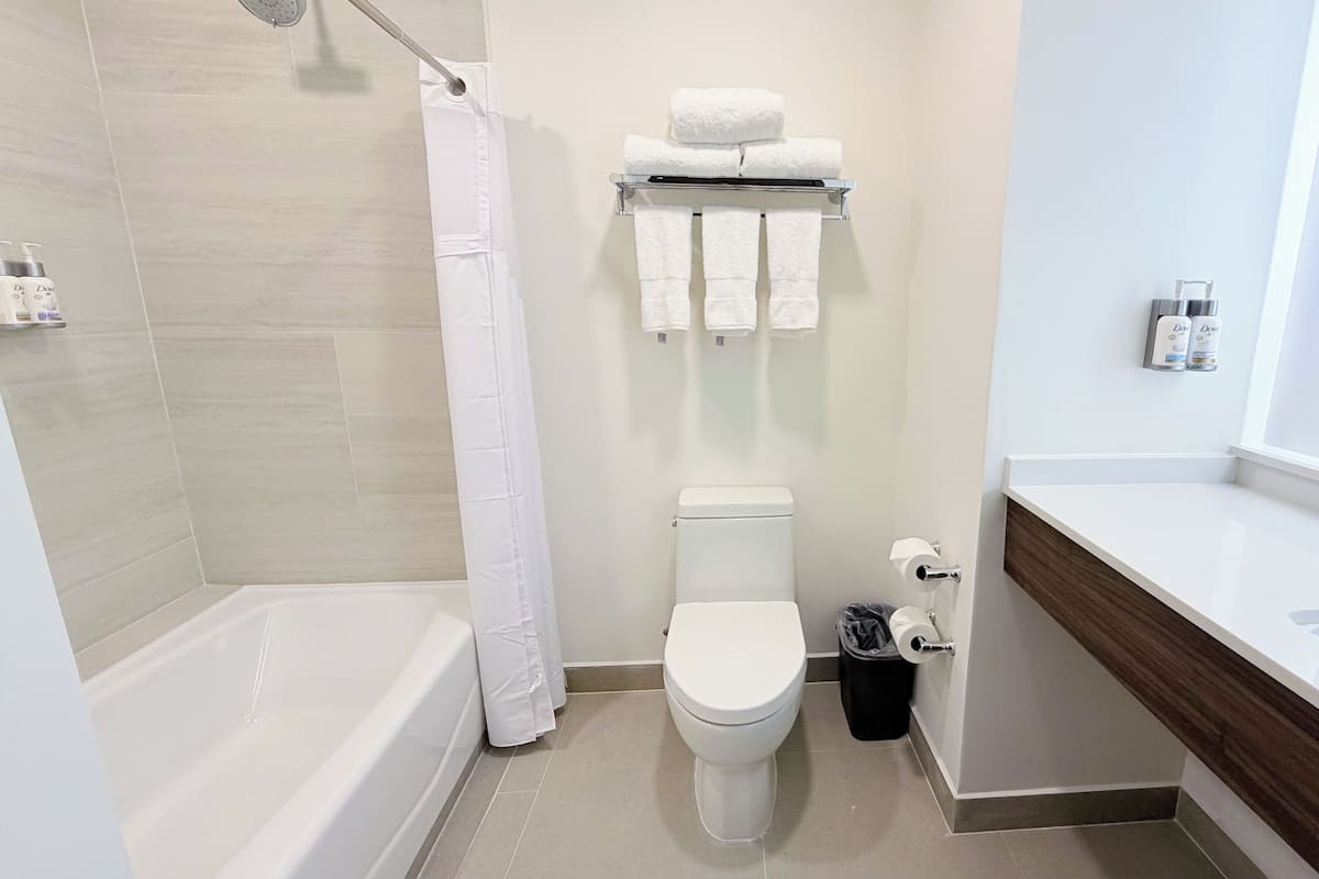 Suite, 1 King Bed, Jetted Tub | Bathroom | Hair dryer, towels, soap, shampoo