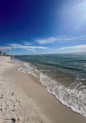 A beach with clear skies, a sandy shore, and a pier in the background. - Robertson Ridge Hideaway Cottage (Hinkle)