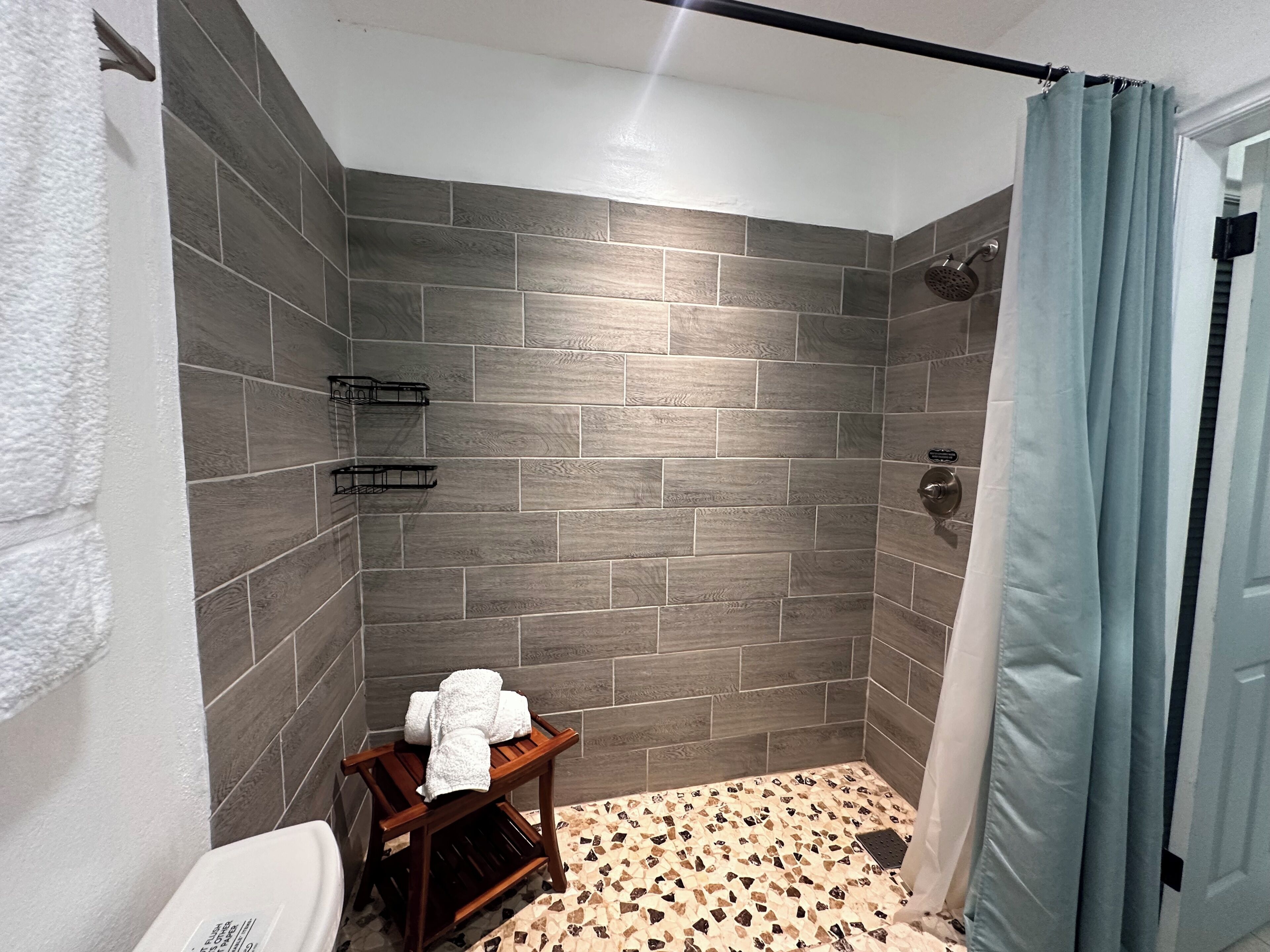 Shower, hair dryer, towels, toilet paper