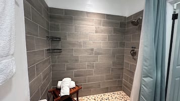 Shower, hair dryer, towels, toilet paper