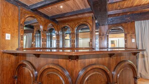 A wooden bar with arched mirrors and a polished surface. - Super Spacious Fun Home! With Pool, Den and Bar (Johannesburg)