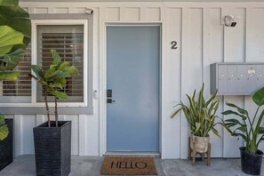 A front door with a "HELLO" mat, number 2, and a mailbox. - 1 Block to Bay - Boutique 1BR with Parking - Mission Beach (San Diego)