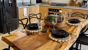 A modern kitchen with wooden cabinets, a black refrigerator, a microwave, and a gas stove.