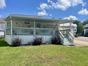 A single-story building with a covered porch and a staircase leading to the entrance. - 6010 Almost Heaven By The Sea (Myrtle Beach)