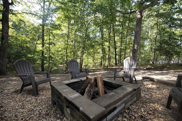 Private woodland fire pit with Adirondack seating—s’mores under the trees!