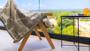 A balcony with a view, a wooden chair, a small table with cups and a glass of orange juice. - Luxury apartment LaRiv II with pool (Krk)