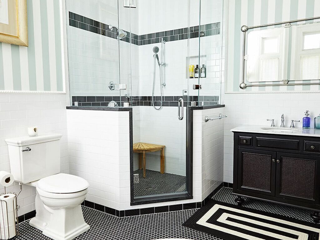 A modern bathroom with a shower, toilet, and sink.