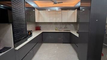 Full-size fridge, microwave, cookware/dishes/utensils