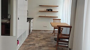 Luxury Studio Suite, Garden View | Private kitchen | Coffee/tea maker, highchair