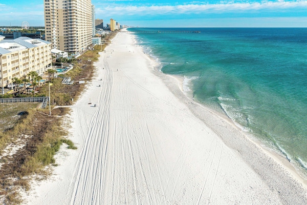 Pristine Panama City Beach shoreline with crystal-clear emerald waters