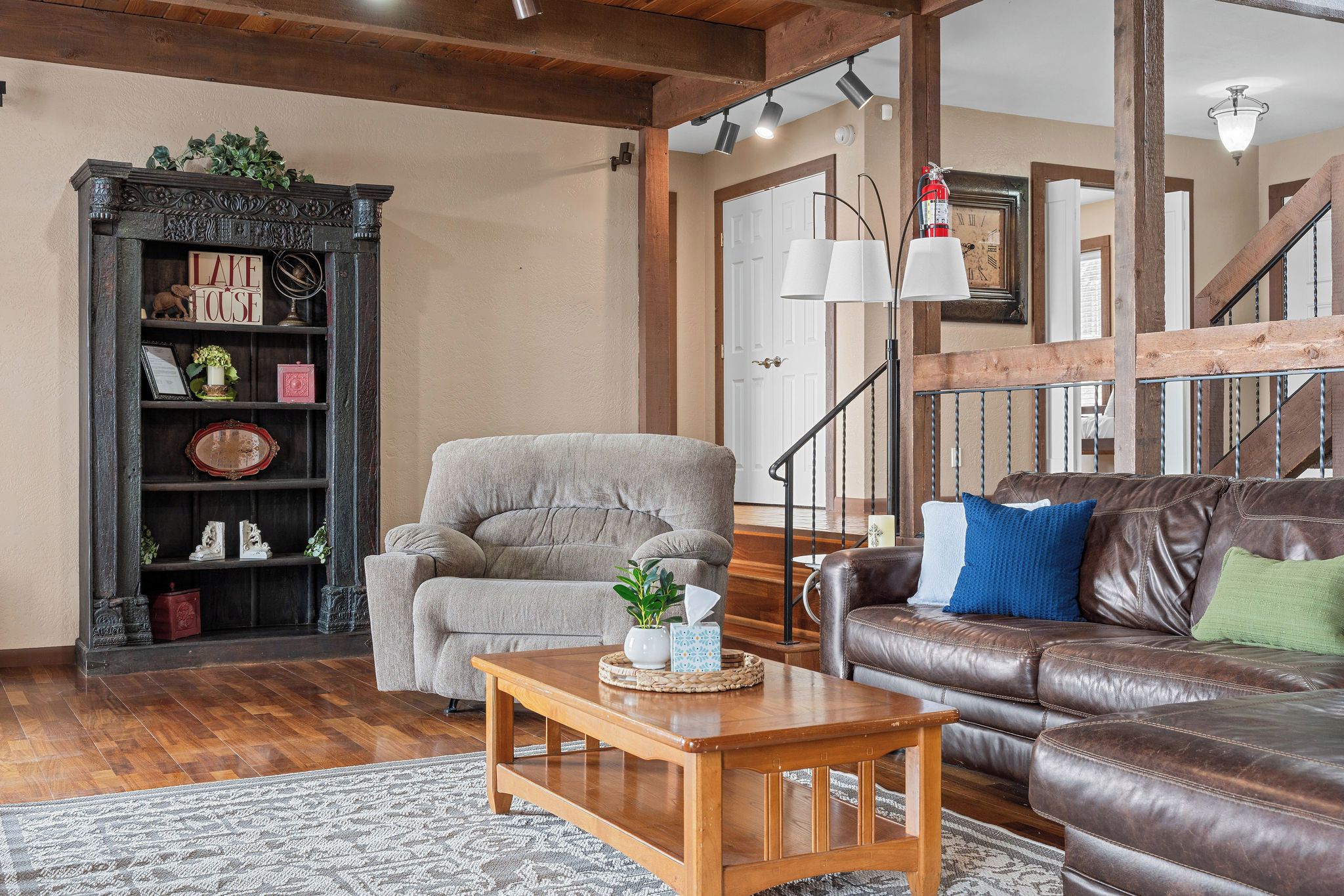A living room with a fireplace, a sofa, a coffee table, and a bookshelf.