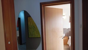 A hallway with a wooden door leading to a bedroom. - LAGOS RESIDENCES 4BED IKOYI HC (Lagos)