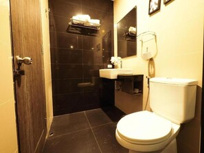 A bathroom with a toilet, sink, and shower area. - BB House Chaingmai (Chiang Mai)