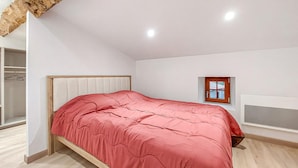 A bedroom with a bed, a wardrobe, a window, and a ceiling light. - 1 bedroom lovely home in Verteuil-sur-Charente (Verteuil-sur-Charente)